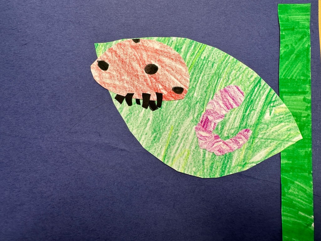 A paper collage of a ladybug and caterpillar on a leaf