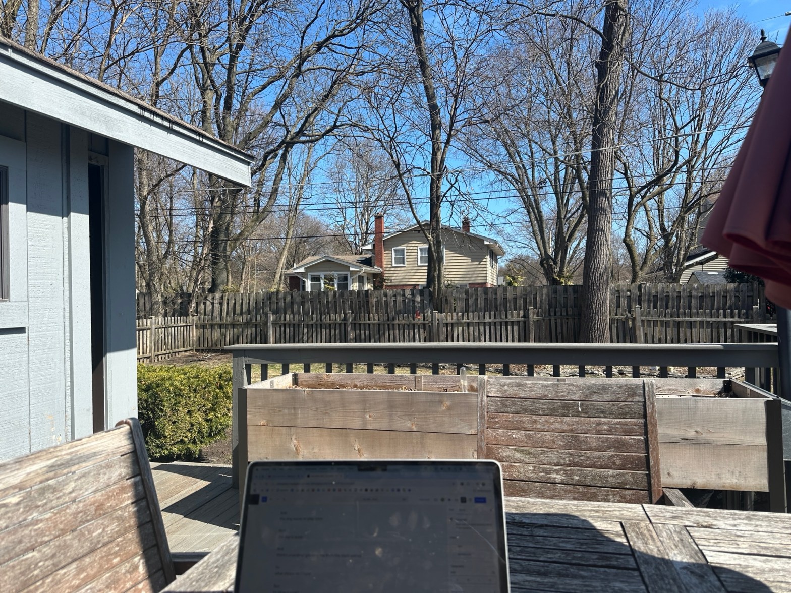 Picture looking out from a deck to a back yard
