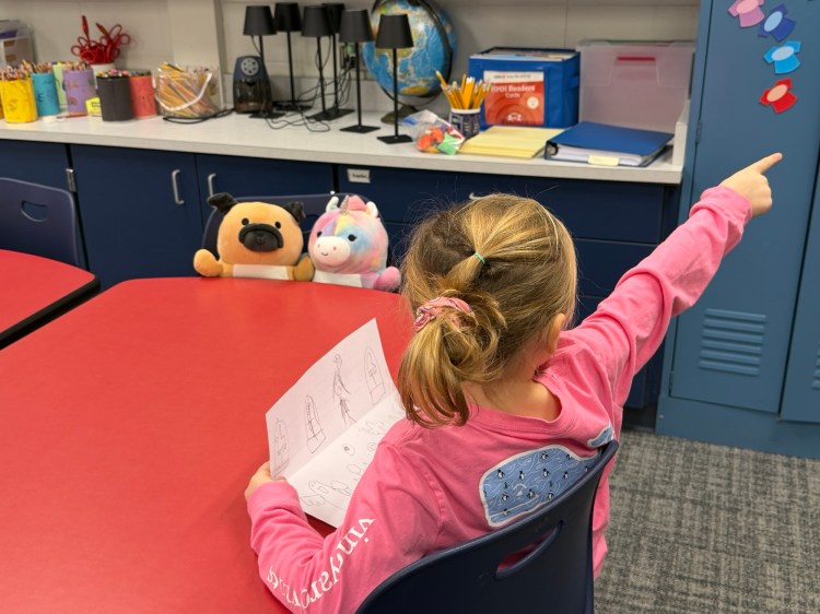 Girl telling stories to stuffed animals