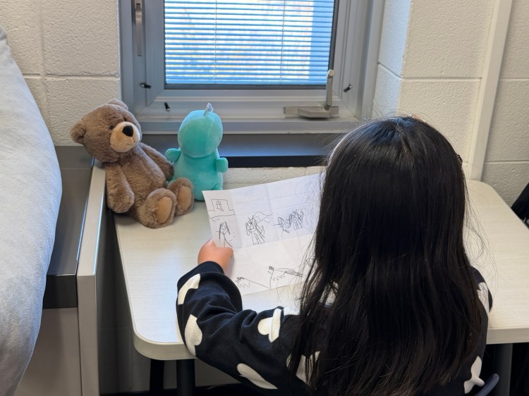 Girl telling stories to stuffed animals